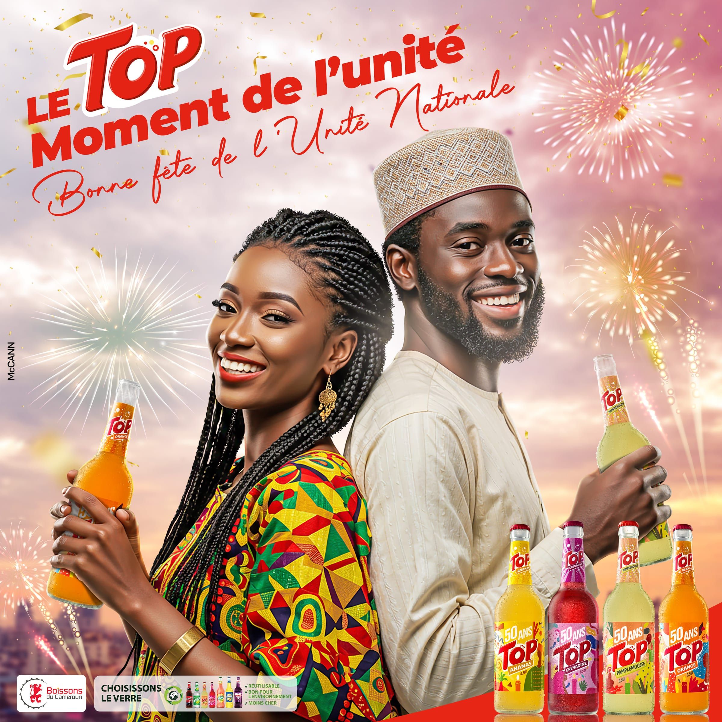 Visuel « Le Top moment de l'unité — Bonne fête de l'Unité nationale » : une jeune femme et un jeune homme dos à dos sous des feux d'artifice, bouteilles de Top en main.